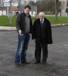 Cllr Dennis McGonagle and local election candidate Charlie McConalogue viewing the damaged road surface in Malin prior to repair work starting this week.